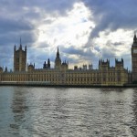 Houses of Parliament on far side of river, showing Gothic spires against dramatic sky