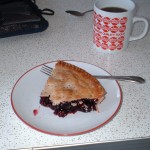 half-eaten piece of pie, mug of coffee, formica table top