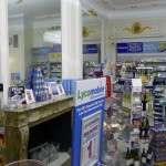Merchandise in a variety store beside a marble fireplace, large mirror, luxurious look